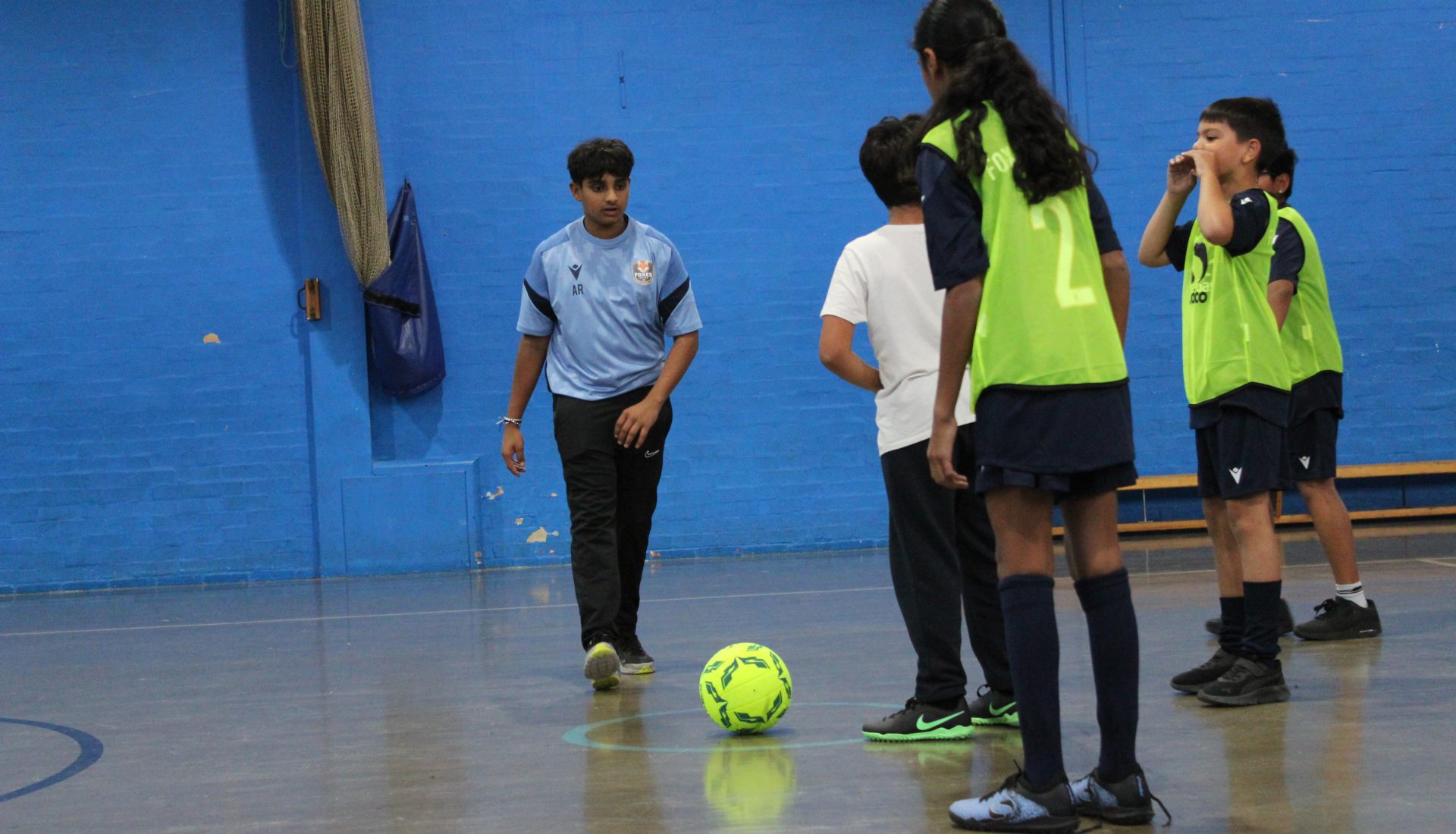 Football coach playing with the kids football